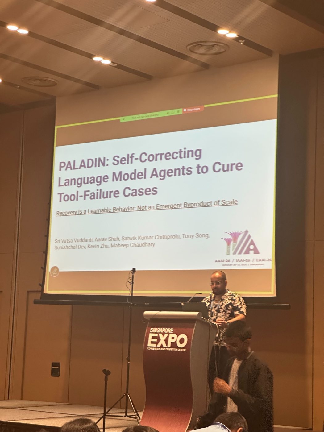 Algoverse student delivering PALADIN oral presentation at AAAI 2026 in Singapore