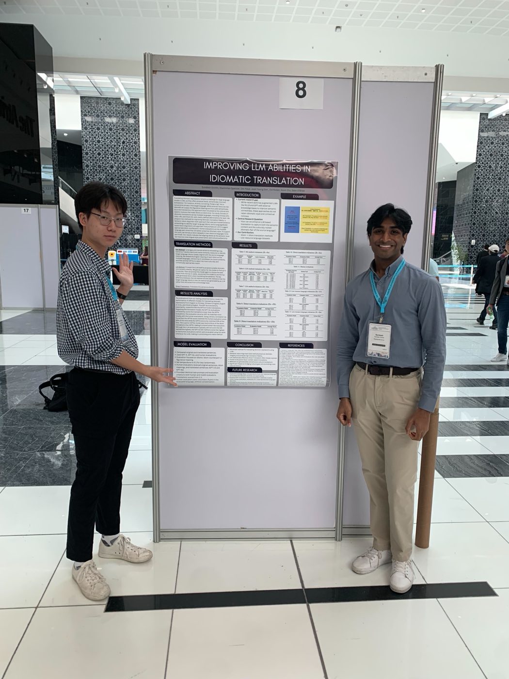 Two Algoverse students presenting low-resource axiomatic translation poster at COLM 2025
