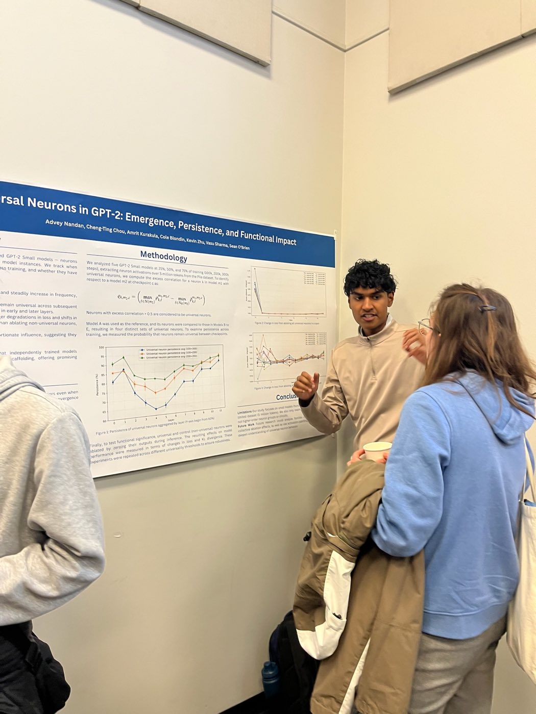 Algoverse student presenting Universal Neurons in GPT-2 research poster at COLM 2025