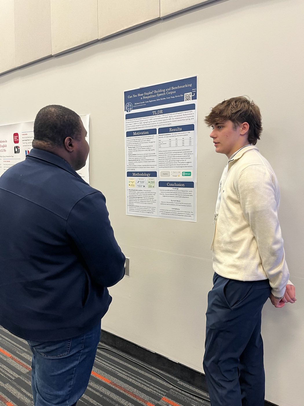 Algoverse student discussing Neapolitan speech corpus research poster with attendee at COLM 2025