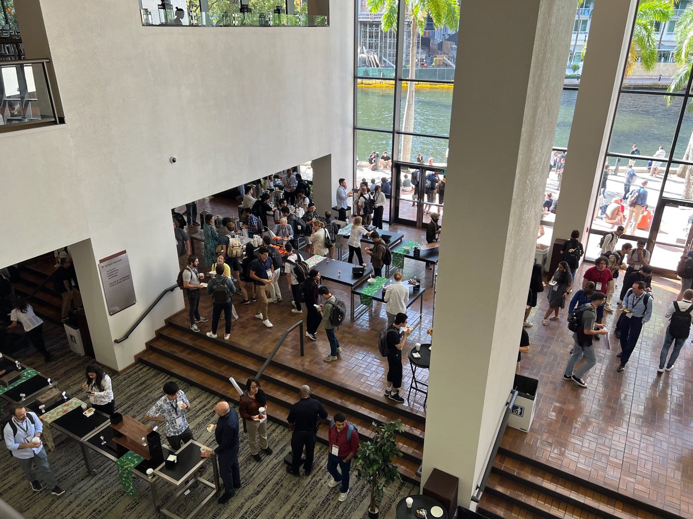Overhead view of attendees gathered in the EMNLP 2024 venue lobby in Miami