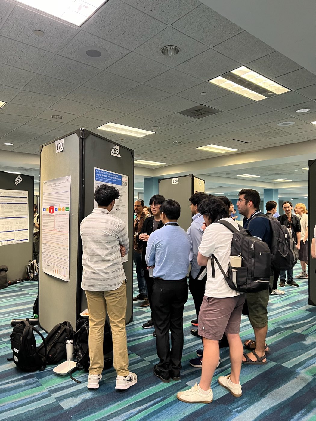 Attendees gathered around an Algoverse poster at the EMNLP 2024 poster session