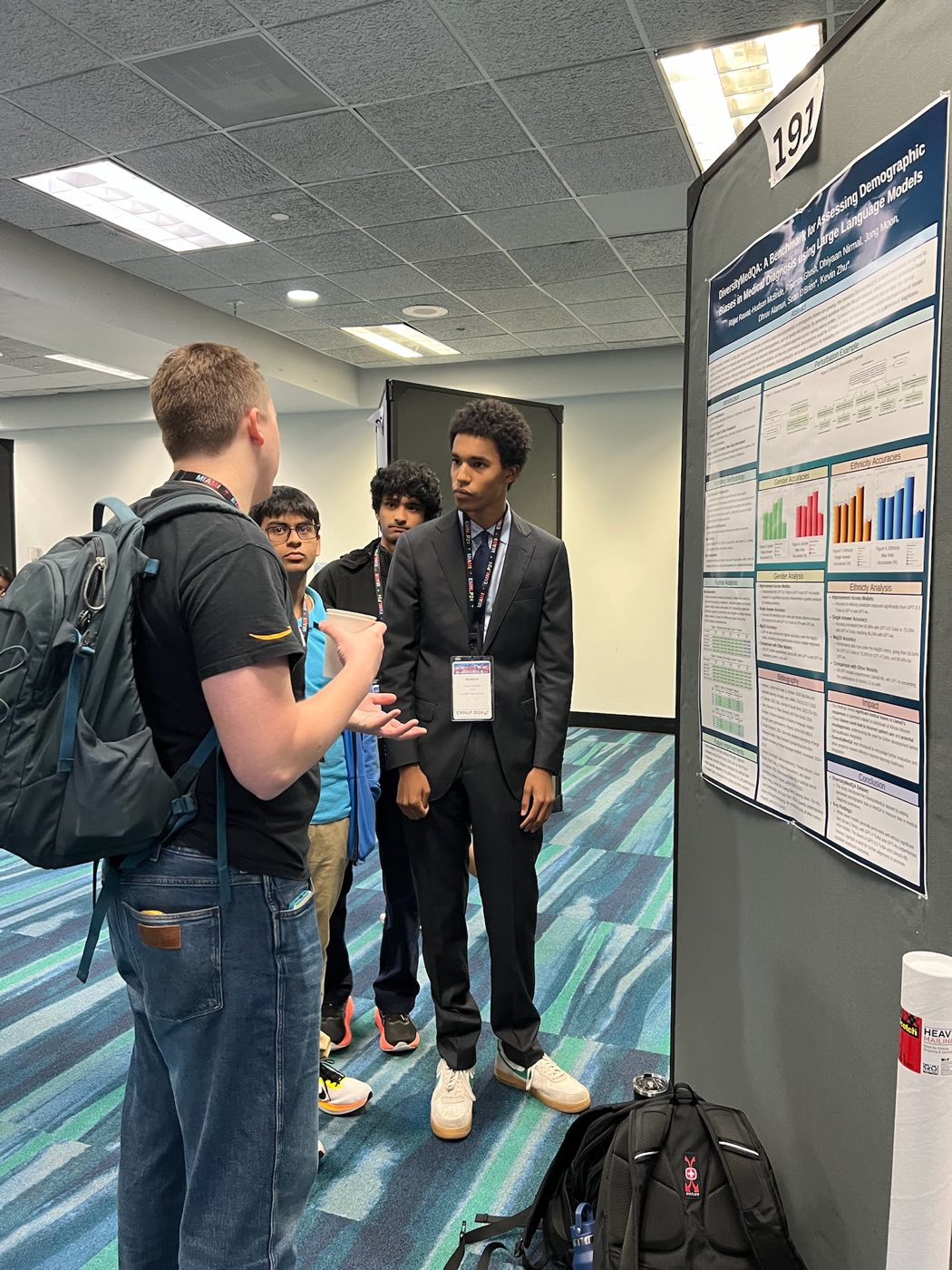 Algoverse student presenting research poster to an attendee at EMNLP 2024