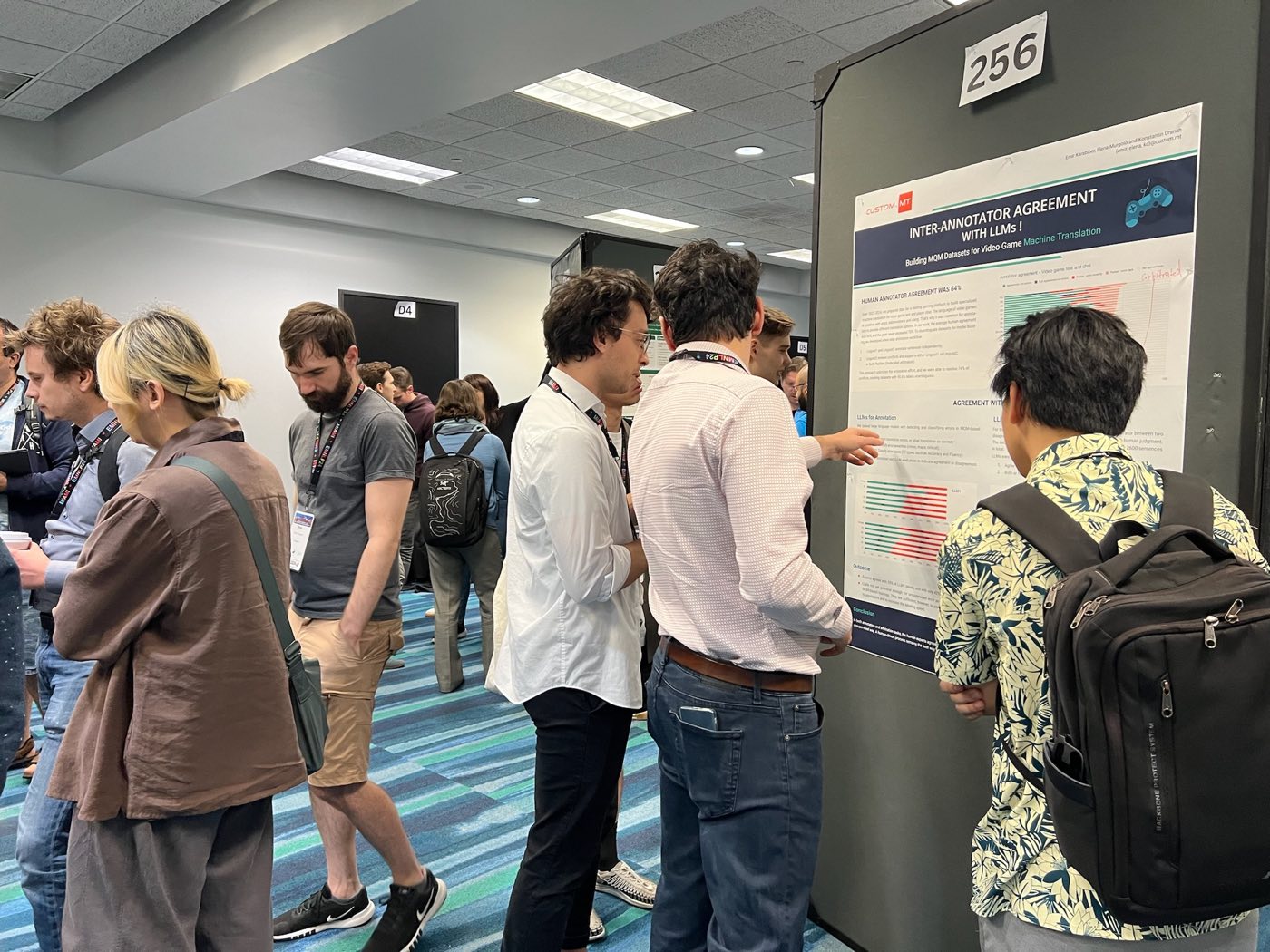 Algoverse researcher discussing inter-annotator agreement poster with attendees at EMNLP 2024