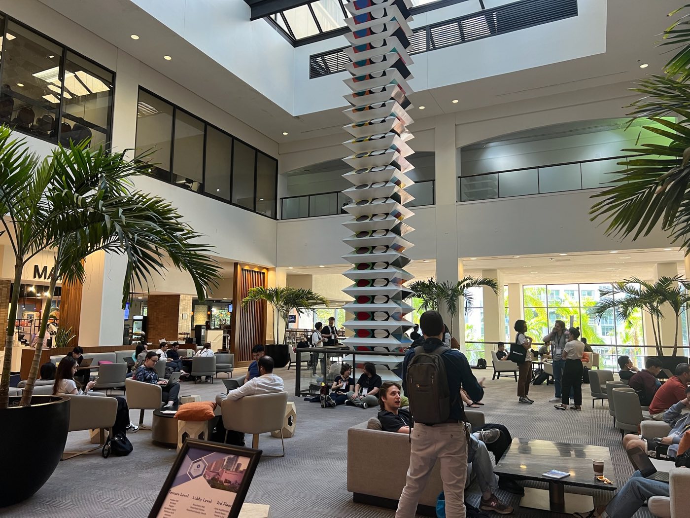 Attendees relaxing in the EMNLP 2024 venue lounge area