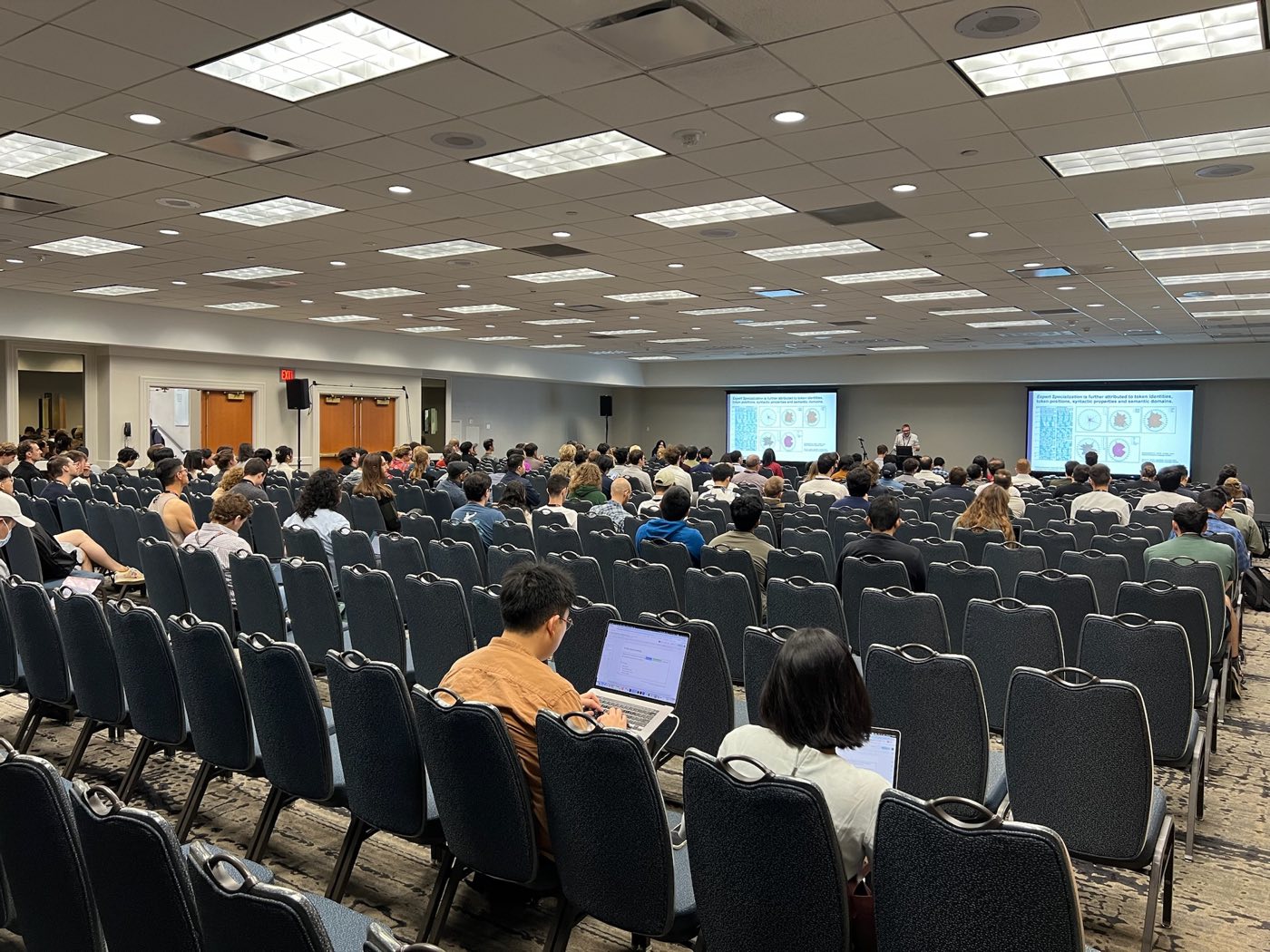 Algoverse attendees seated in a packed session room at EMNLP 2024