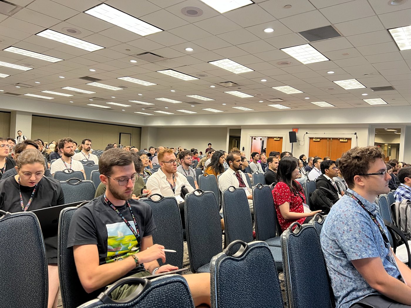 Audience listening to a presentation at EMNLP 2024