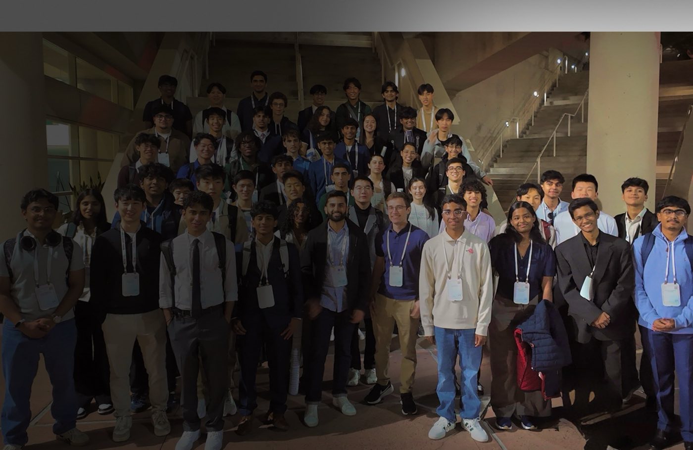 Large Algoverse cohort group photo at a conference venue