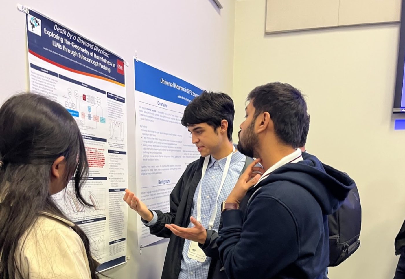 Algoverse students discussing research posters at conference