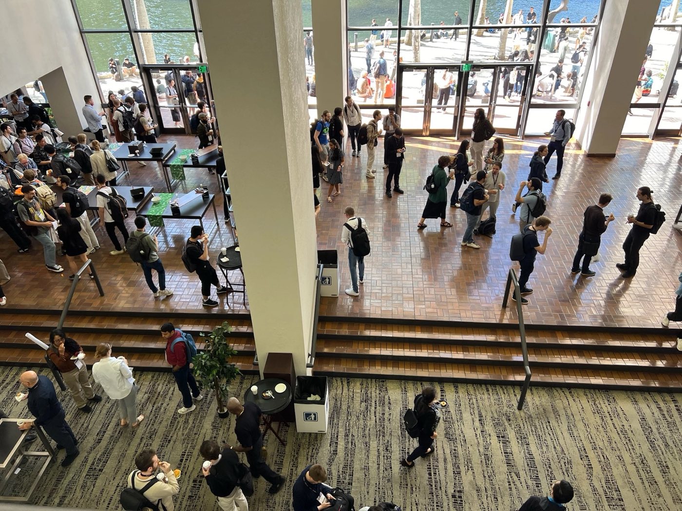 Attendees filling a conference lobby and poster hall