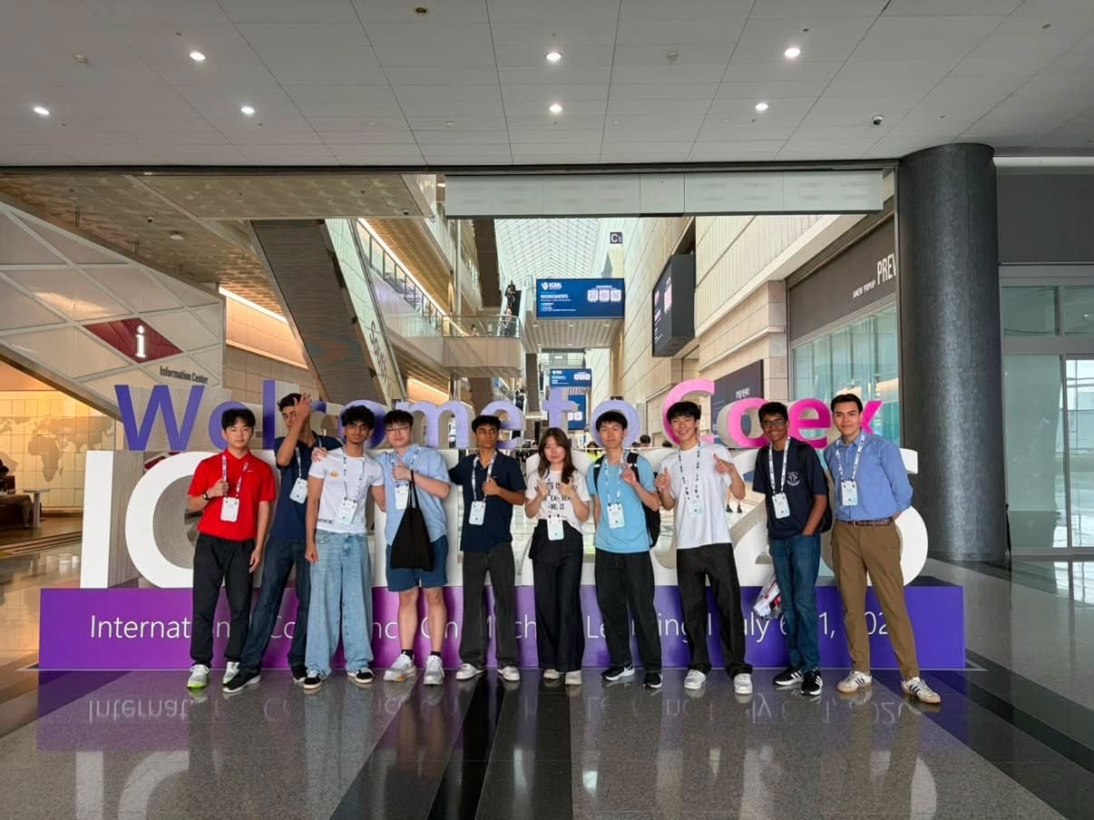Algoverse students posing at the ICML 2026 welcome sign at COEX in Seoul