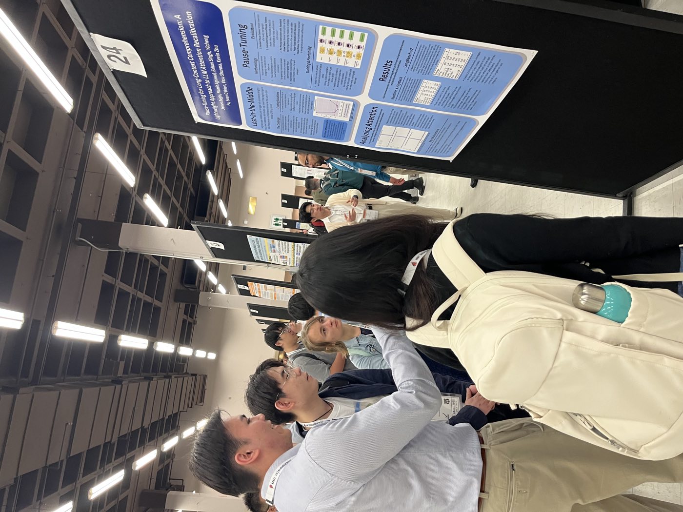 Algoverse students reviewing research poster at NAACL 2025