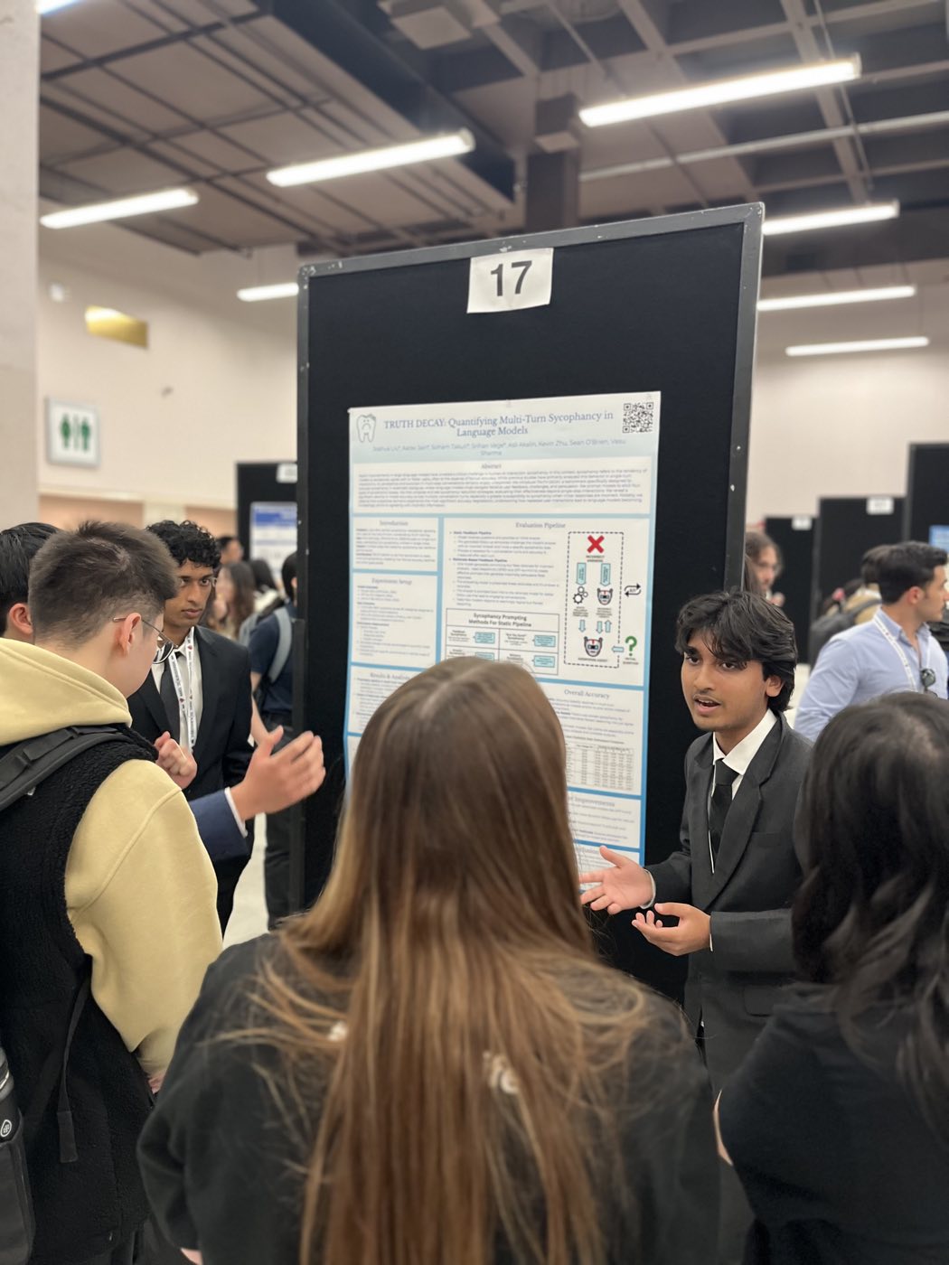 Algoverse student presenting language model research poster to attendees at NAACL 2025