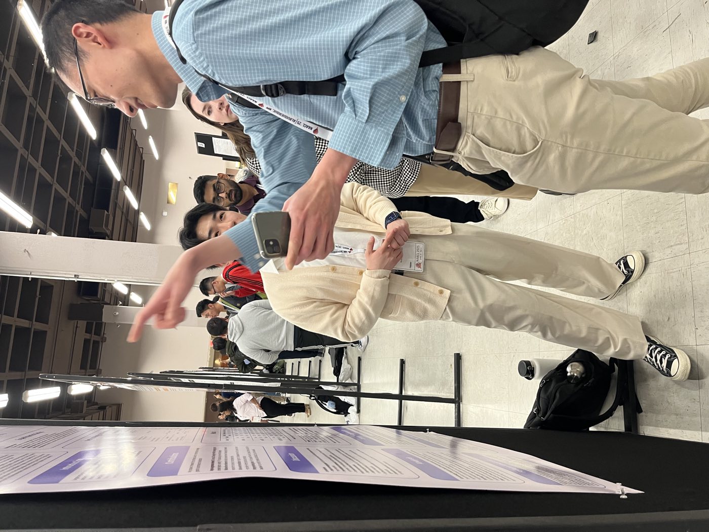 Algoverse student explaining research to attendee at NAACL 2025