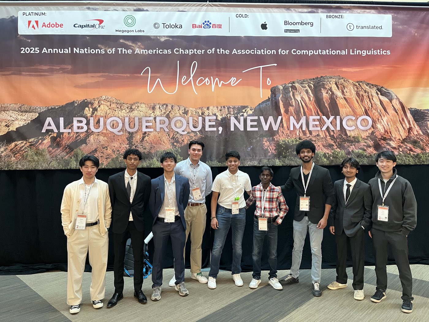 Algoverse students posing in front of the NAACL 2025 Albuquerque welcome banner