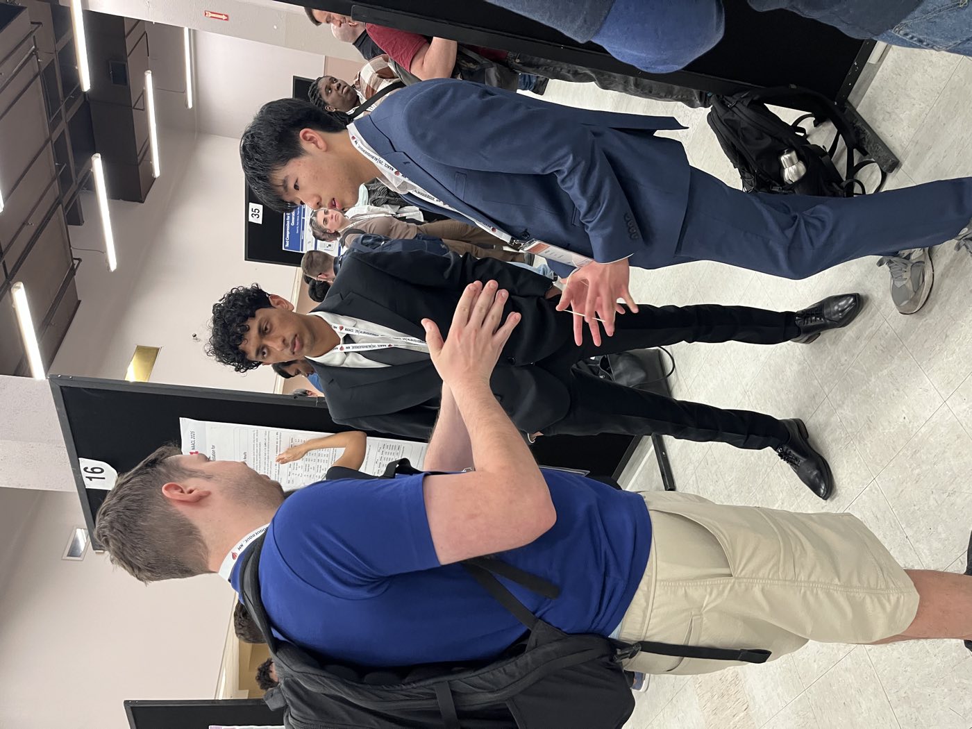 Algoverse students discussing research with attendees at NAACL 2025